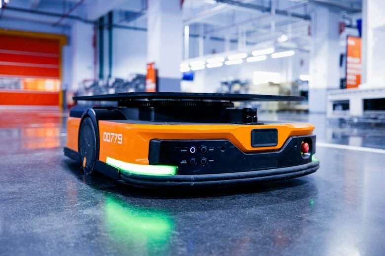 An automated guided vehicle carrying parts across a factory floor