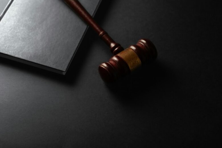 Judge's gavel and law book on a dark background