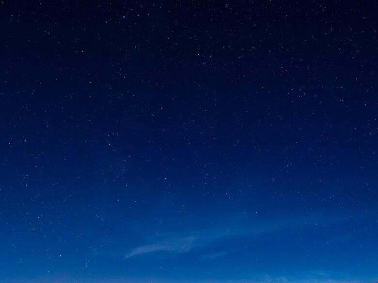 A dark blue night sky filled with scattered stars