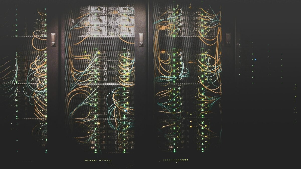 Server racks and network cables in a data center; illustrative photograph.
