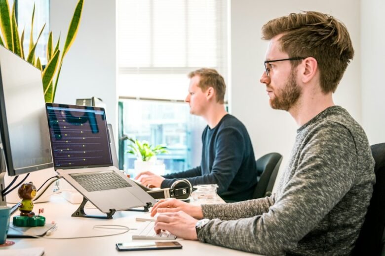 Technology employees working at computers, illustrative image