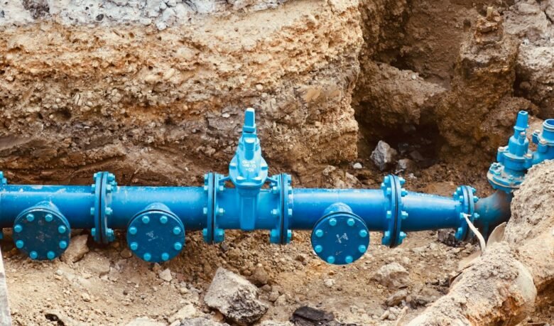 Large blue utility pipe at an infrastructure construction site